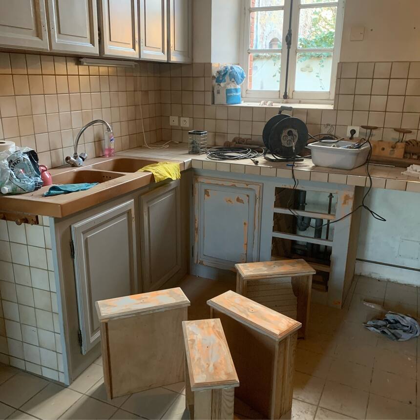 Sanding down the cabinets in the kitchen of the gite. Yes it was painted coral